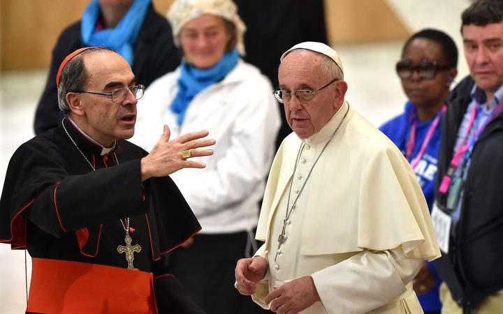 Pope Francis (R) listens to French Cardinal Philippe Barbarin, who was convicted for his role in covering up the sexual abuse of minors.