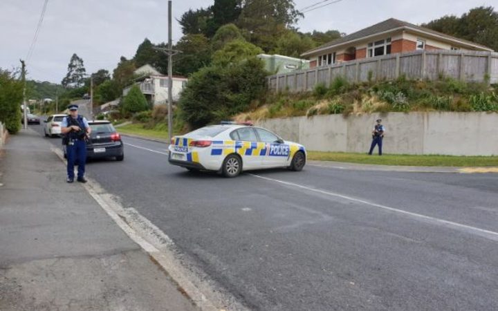 Police at the scene on Somerville St in Dunedin earlier today. Photo / Tim Brown