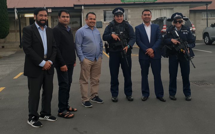 Community members from the Rasol-O-Allah Islamic Centre with armed police. 