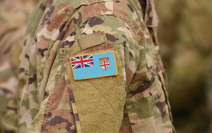 Flag of Fiji on soldiers arm. Flag of Fiji on military uniforms (collage).