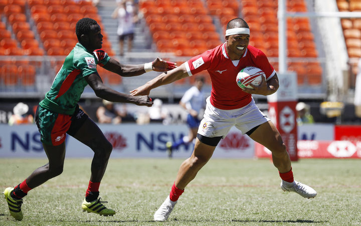 Tonga's Tana Fotofili evades the Kenyan defence in Sydney.