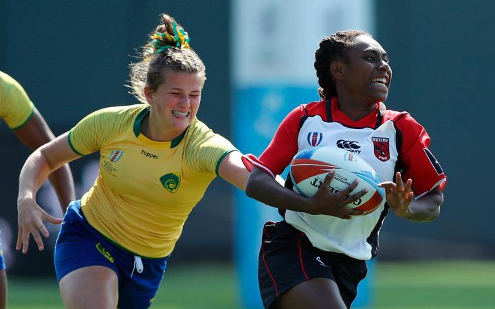 Papua New Guinea's Chelsea Garesa races away from the Brazil defence.
