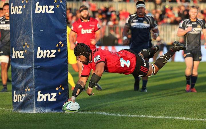 Jordan Taufua of the Crusaders dives over to score a try. against the ACT Brumbies. 