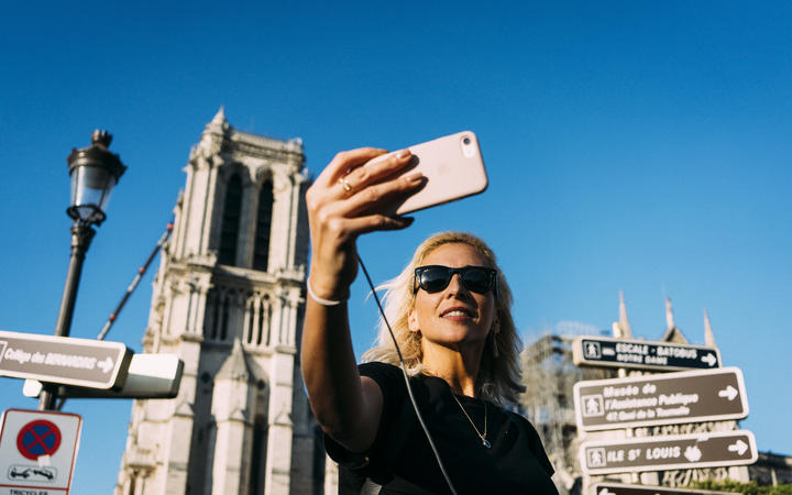 On the first weekend after the fire that devastated Notre-Dame de Paris Cathedral, tourists swarmed in front of the historic monument and took selfies.