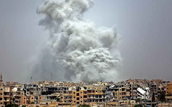 Smoke billows out from Raqqa following a US-led coalition air strike.