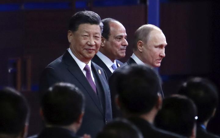 From left, Chinese President Xi Jinping, Egypt's President Abdel-Fattah El-Sisi and Russian President Vladimir Putin arrive for the opening ceremony of the second Belt and Road Forum for International Cooperation (BRF) in Beijing, 