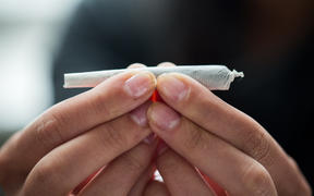 drug use, substance abuse, addiction and people concept - close up of addict hands with marijuana joint