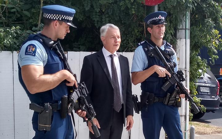 Phil Goff with armed police officers at Otahuhu.
