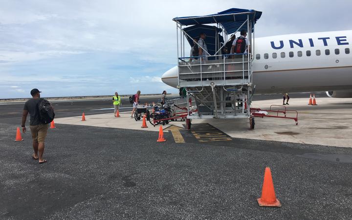 People boarding a flight in Majuro bound for Guam