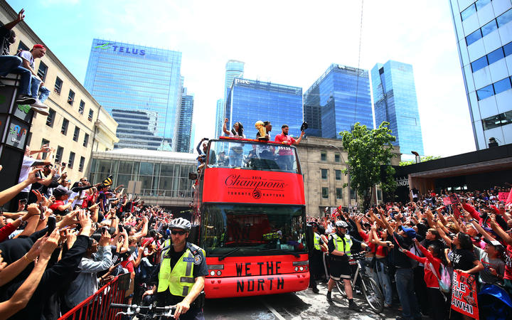 TORONTO, ON - JUNE 17: Kyle Lowry #7 and Fred VanVleet #23 of the Toronto Raptors with the championship trophy during the Toronto Raptors Victory Parade on June 17, 2019 in Toronto, Canada.