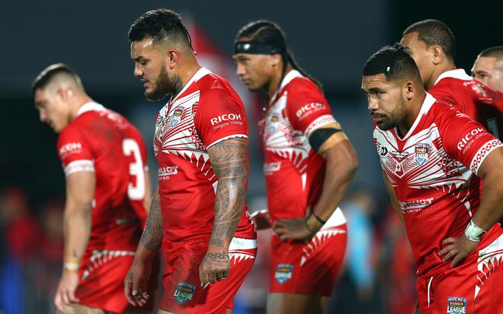 Tongan players stand dejected during Saturday's heavy defeat by the Kiwis.