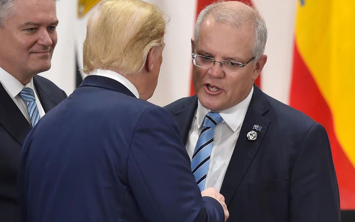 Australia's PM Scott Morrison greets Donald Trump at the G20 meeting in Osaka. Back home, Australia's economy is in trouble.