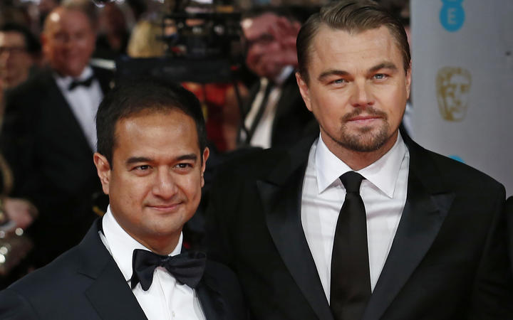 (FILES) In this file photo taken on February 16, 2014, US producers Riza Aziz (L) with US actor Leonardo DiCaprio (R) arrive on the red carpet for the BAFTA British Academy Film Awards at the Royal Opera House in London.