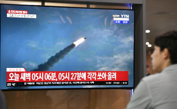 A man watches a television news screen showing file footage of a North Korean missile launch, at a railway station in Seoul on 31 July, 2019. 