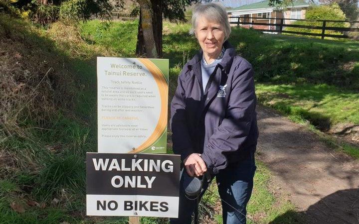 Jessica Maxwell with a walking only sign at Tainui Reserve in Havelock North.