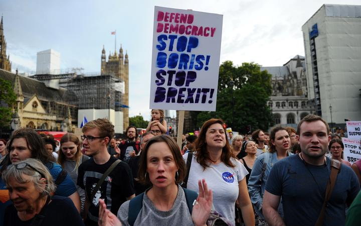 Anti-Brexit demonstrators march from Britain's Houses of Parliament to Downing Street in protest at Prime Minister Boris Johnson's announcement that Parliament will be suspended for more than a month.