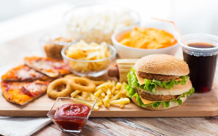 Close up of fast food snacks and drink on table.