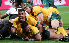 Australia's Tolu Latu celebrates after scoring one of his tries during the second half of the match against Fiji at the Rugby World Cup.