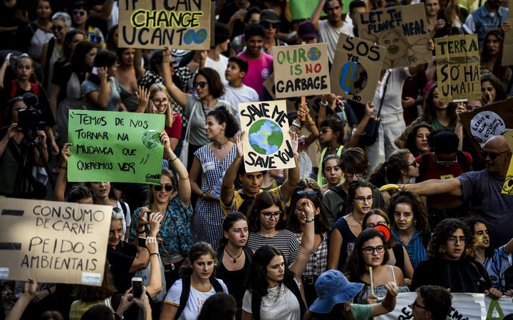Demonstrators take part in a global youth climate action strike in Lisbon.