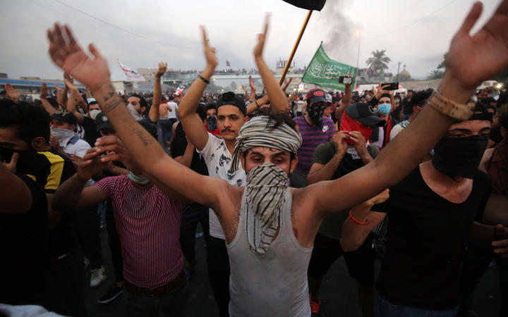 Iraqi protesters chant slogans during a demonstration against state corruption, failing public services and unemployment at Tayaran square in Baghdad.