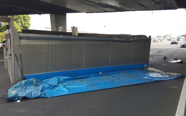 The truck lay on its side after hitting the overbridge.