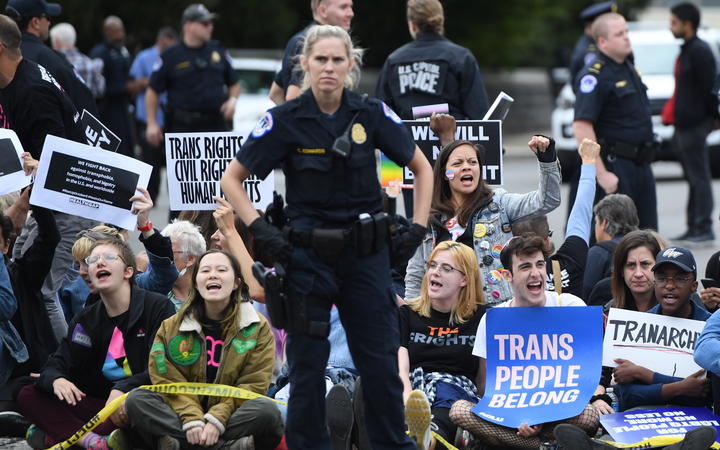 Demonstrators in favour of LGBT rights do a sit-in as they rally outside the US Supreme Court in Washington, DC, October 8, 2019, as the Court holds oral arguments in three cases dealing with workplace discrimination based on sexual orientation. (Photo by SAUL LOEB / AFP)