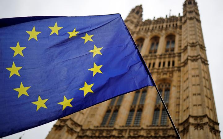 A European Union flag and belonging to an anti-Brexit activist flies outside the Houses of Parliament in London on October 23, 2019. 