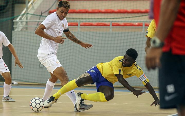 Solomon Island's captain Elliot Ragomo is brought down by Tahiti's Steeve Wong. OFC Futsal Nations Cup 2019