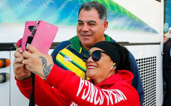 Australian coach Mal Meninga poses with a Tongan fan 