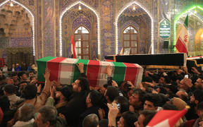 Mourners carry the coffins of slain Iraqi paramilitary chief Abu Mahdi al-Muhandis, Iranian military commander Qasem Soleimani and eight others inside the Shrine of Imam Hussein in the holy Iraqi city of Karbala during a funeral procession on 4 January. 