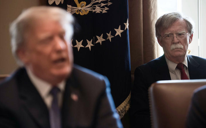 (FILES) In this file photo taken on April 9, 2018 New National Security Adviser John Bolton(R) listens to US President Donald Trump speak during a cabinet meeting at the White House in Washington, DC.