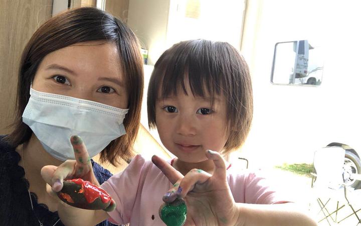Lily Gao painting rocks with her 2yo daughter Elysse in the campervan.