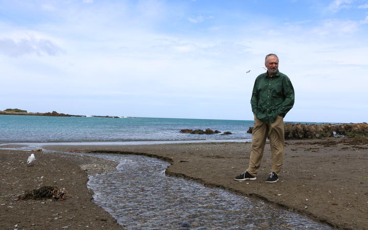 Eugene Doyle at the outlet at Ōwhiro Bay that, in recent months, has measured 30 times the level of fecal contamination considered safe to swim. 