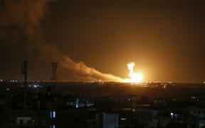 A ball of fire is seen following an Israel airstrike at Rafah in the southern Gaza Strip early on February 23, 2020.