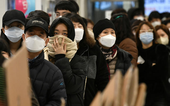 People wait in a line to buy face masks at a shop in the city of Daegu, South Korea, 22 February 2020. 