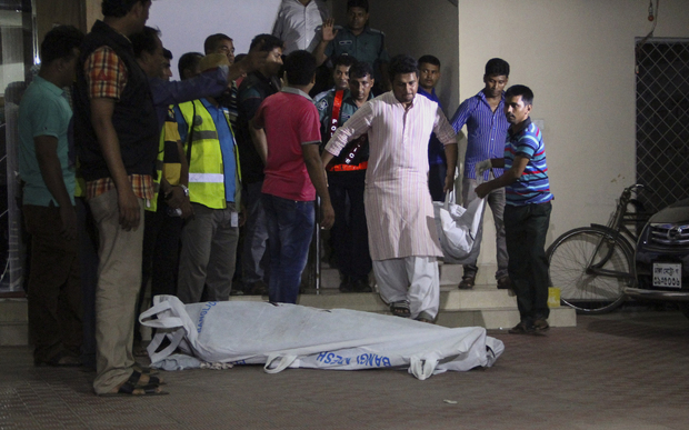The bodies of two gay rights activists who were hacked to death are brought down from an apartment in Dhaka