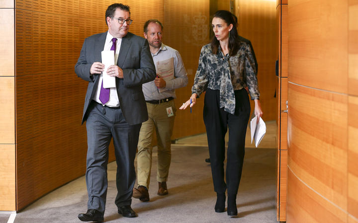 Prime Minister Jacinda Ardern and Finance Minister Grant Robertson arrive at a press conference at Parliament.