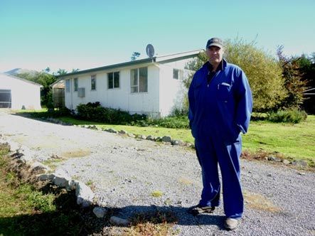 Farmer Mike Hendrin in front of his empty 3 bedroom cottage near Loburn in North Canterbury