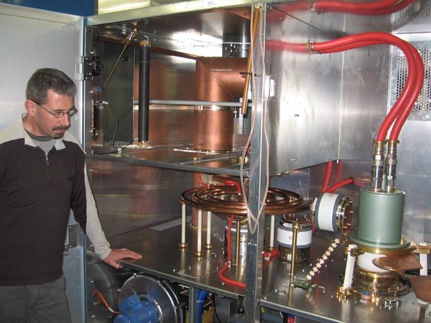 Transmission Engineer Andy Anderson shows off a high power water cooled valve, water cooled inductors and capacitors