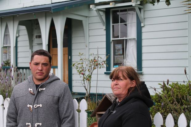 Tarikaka Susan and Arnaru Atkins by the gate of their former home