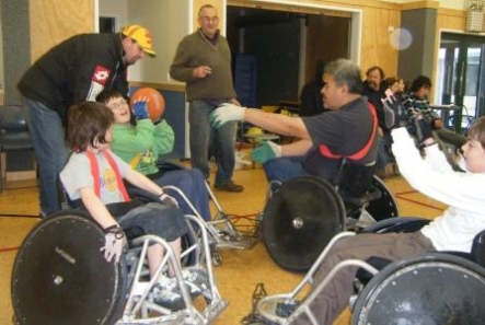 Don Judd (standing, centre) coaches wheelchair rugby.