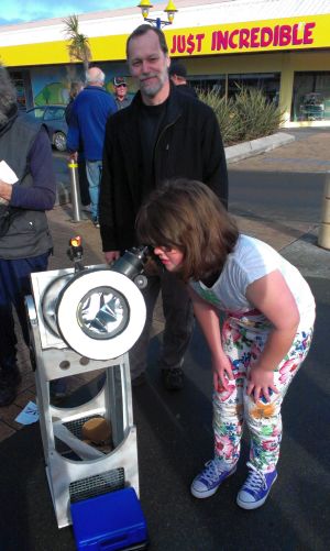 Visitors to the New Brighton Market view the sun through a solar telescope as Urban Astronomer Gary Steel looks on