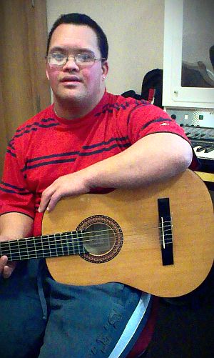 John Halliday is learning the guitar at Living Options