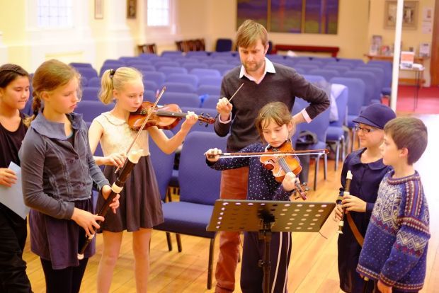 Conductor Robert legg with chamber orchestra from Kelburn Normal School image supplied