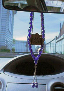 Miniature Qur an surrounded by rosary beads