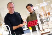 Michael Mucalo and Ho Ying Yuen with the muffin tray that was used a mould for the drug delivery system 