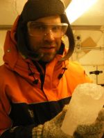 Stefan Jendersie holding a portion of a core of sea ice