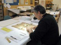 Te Papa conservationist, Vicki, restoring a work on paper.
