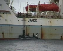 Fishing foreign hoki trawler being checked by Navy