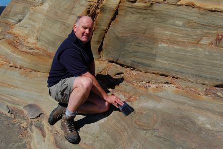 Greg Browne with dinosaur footprints